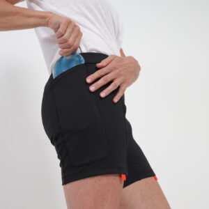 A person secures an ice pack into a specialized pocket on an EasyReach underwear compression therapy wrap worn around their thigh, providing targeted Post-Operative Comfort Wear.