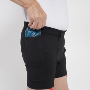 A person in adaptive shorts with a built-in side pocket conveniently stores a gel ice pack, showcasing the functionality of men's adaptive underwear UK.