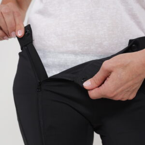 A person showcases the easy-to-adjust waistband feature of a pair of adaptive underwear, making them easier to put on for elderly individuals.