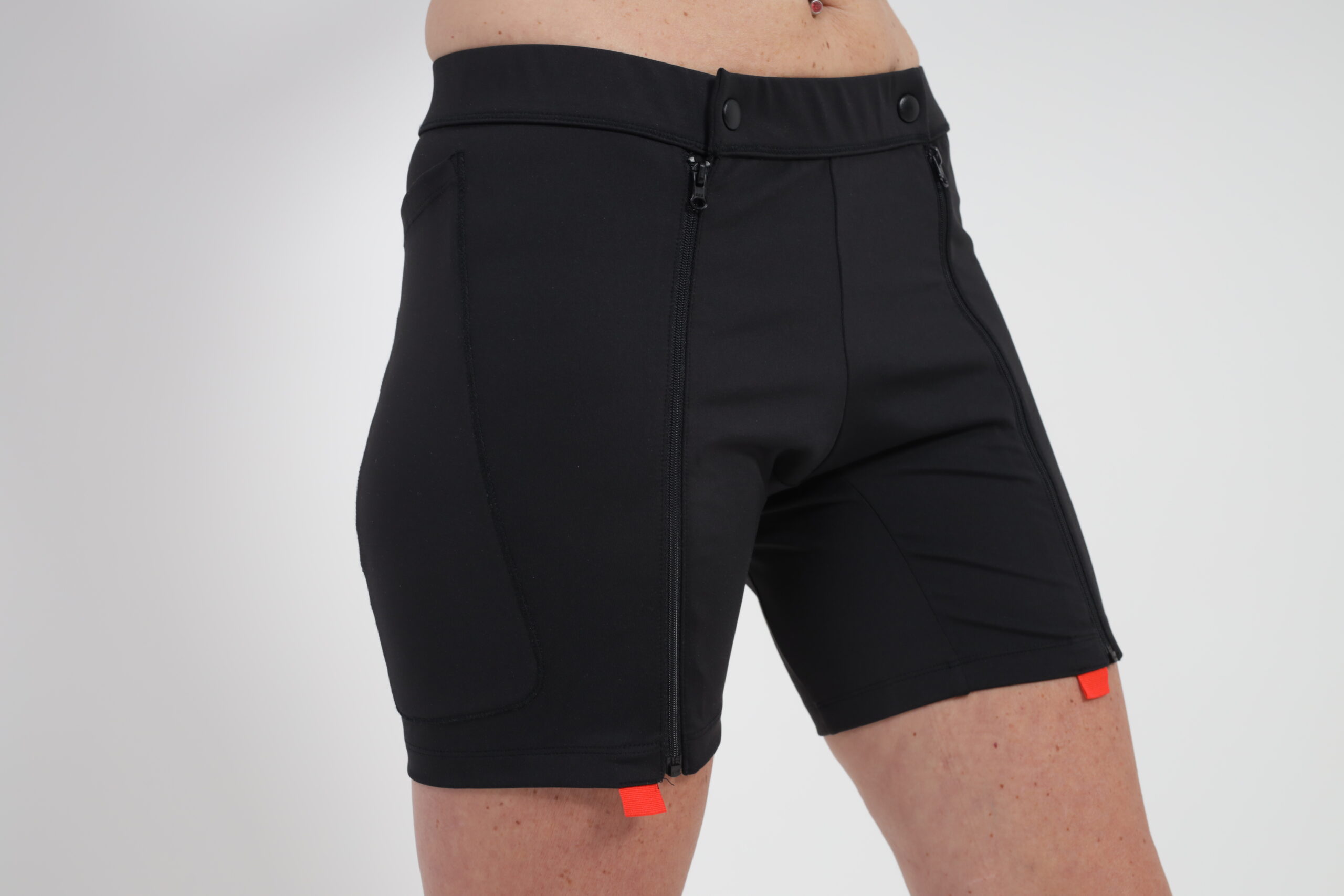 Crafted to ensure comfort following surgery, these black shorts have a stretchable waistband, a subtle red detail at the hem, and are tailored as No-Bend Clothing for Hip Surgery.